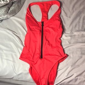 Orangish red bathing suit zips and is padded